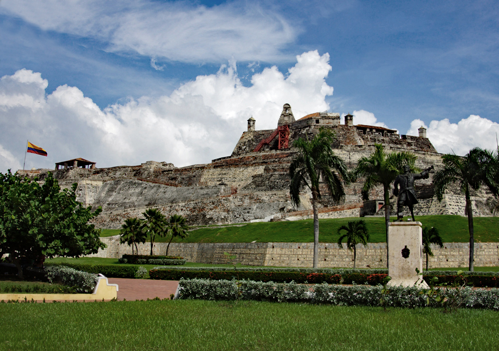 A large historical fort surrounded by grass