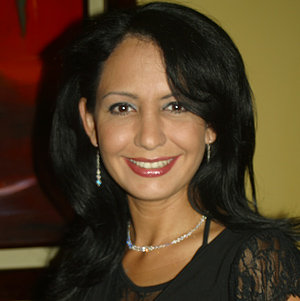 Mature Latin Woman with light skin and dark hair smiling