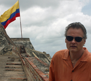 Jamie, the owner of International Introductions a renown marriage agency in South America in Cartagena with the Colombian flag in the background