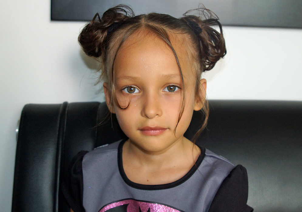 A six year old girl with her hair up