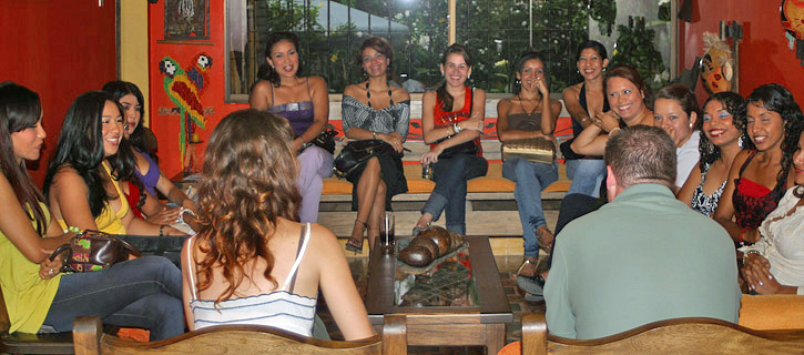 Small Group Introduction with Colombian Women A small group of women meeting one man during a matchmaking tour