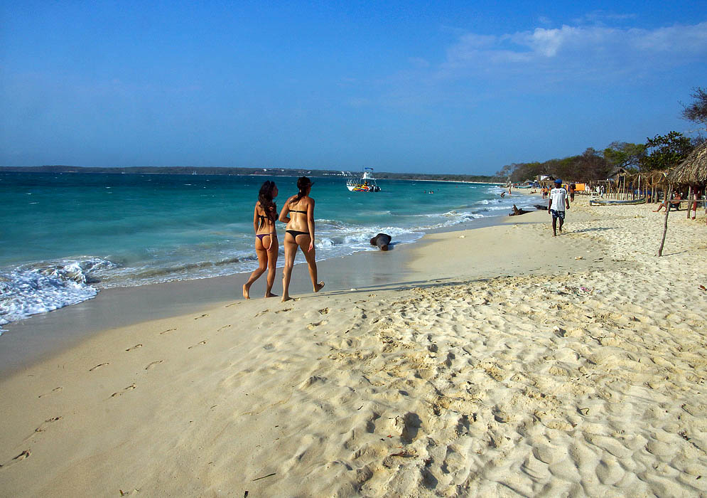 Playa Blanca and Colombian Women Two women walking along the beach at Playa Blanca
