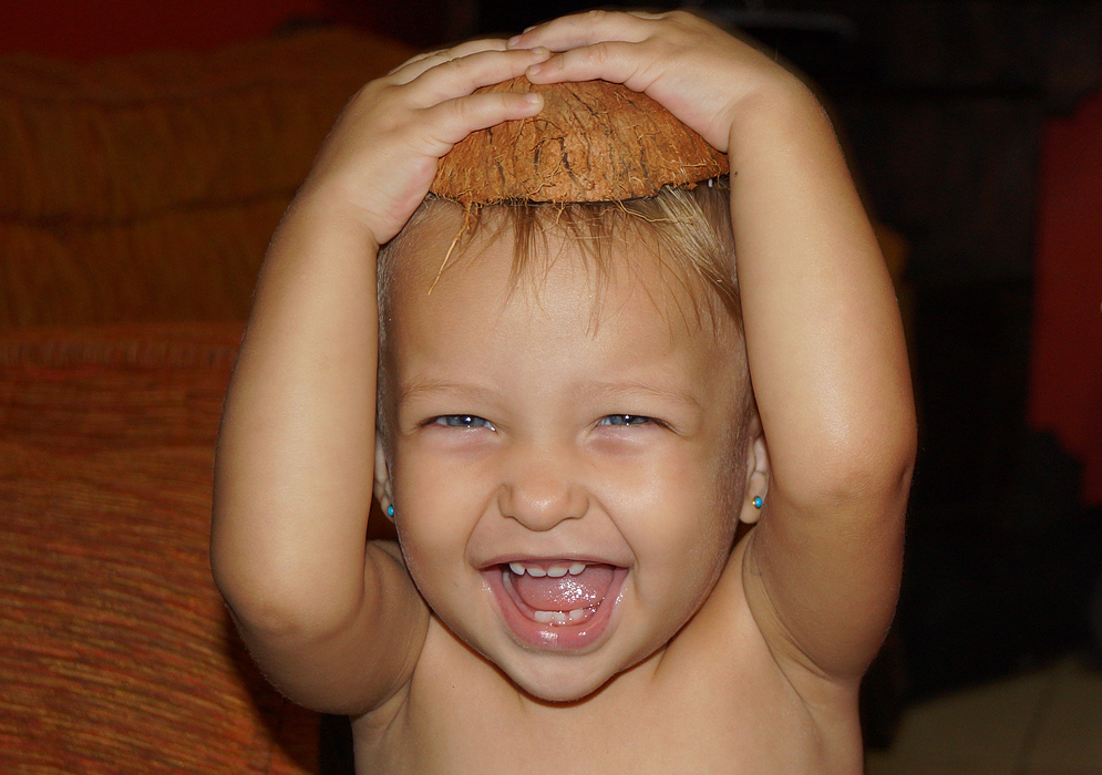 Happy blond Colombian American wearing a coconut shell on her head