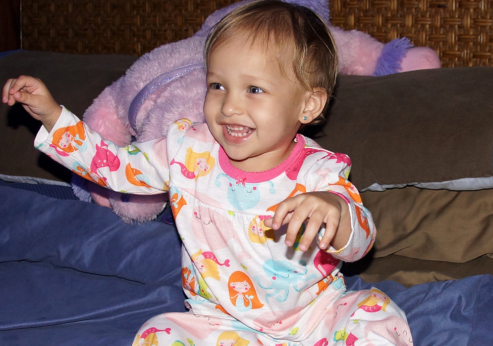 Joyful Colombia American baby playing before bedtime