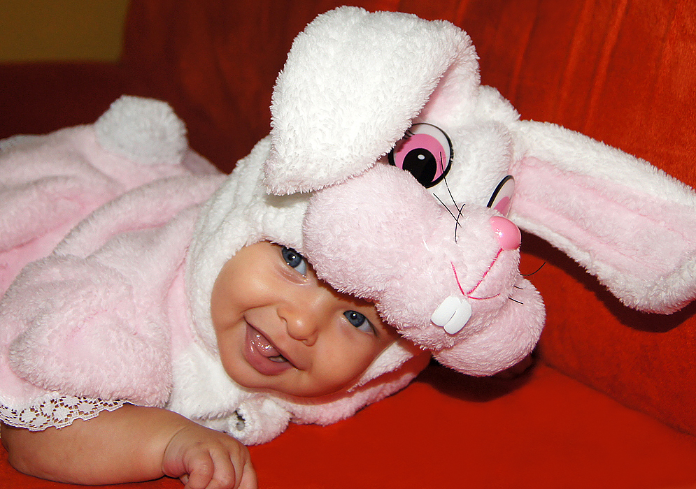 Baby and Rabbit Costume Smiling four month old American Colombian baby wearing her pink rabbit Halloween costume