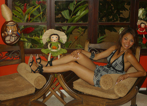 Colombian woman relaxing on a chair in the Barranquilla apartment public area.