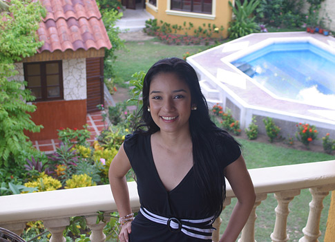 Barranquilla woman standing on a bedroom balcony.