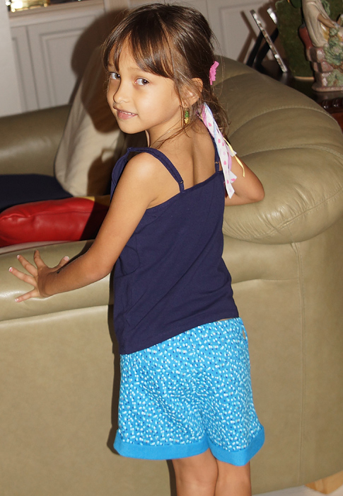 Handsome little girl with blue shorts and blouse