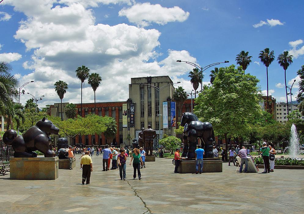 Botero statues in a plaza with a water fountain