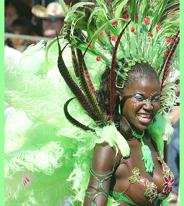 Black Barranquilla woman in green carnival feather costume
