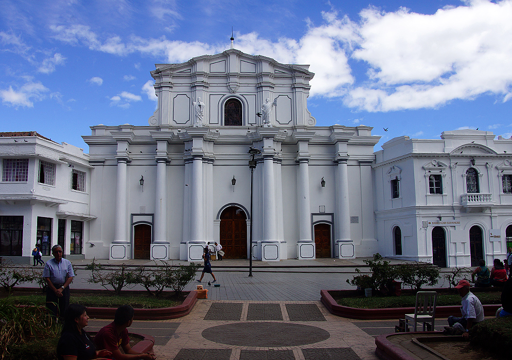 A white church bordering a park