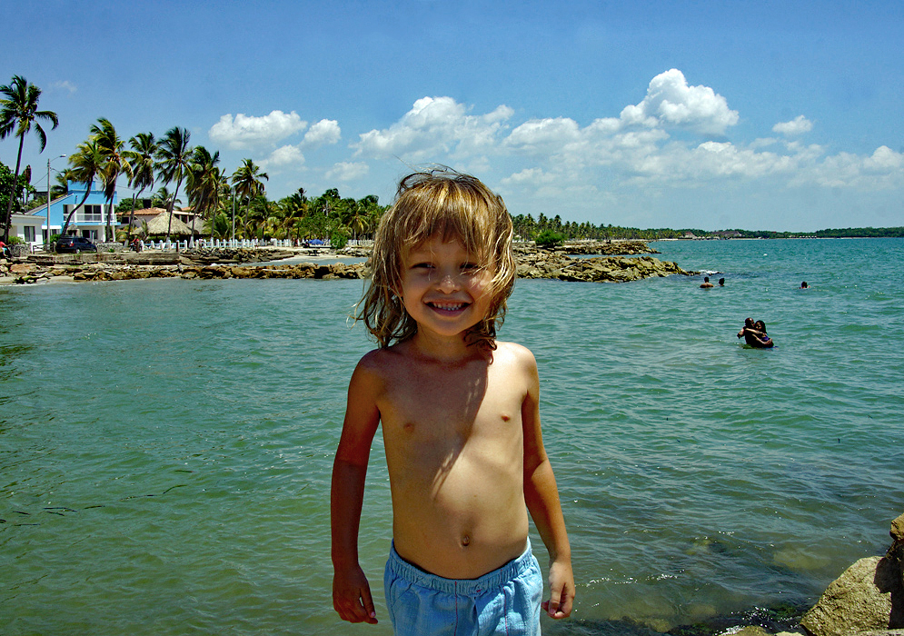 Shirtless three year old enjoying San Antero Beach