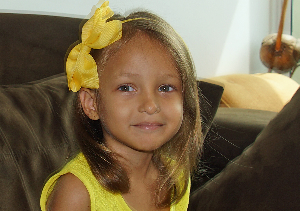 A handsome girl with a large yellow bow in her hair