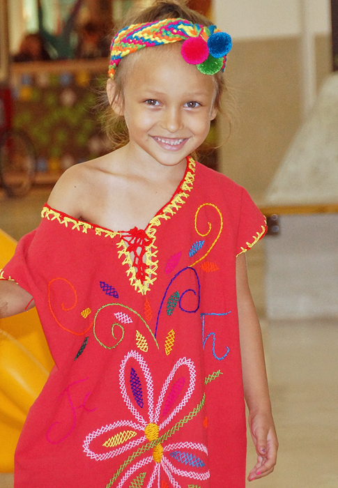 Young girl wearing a red Wayuu dress