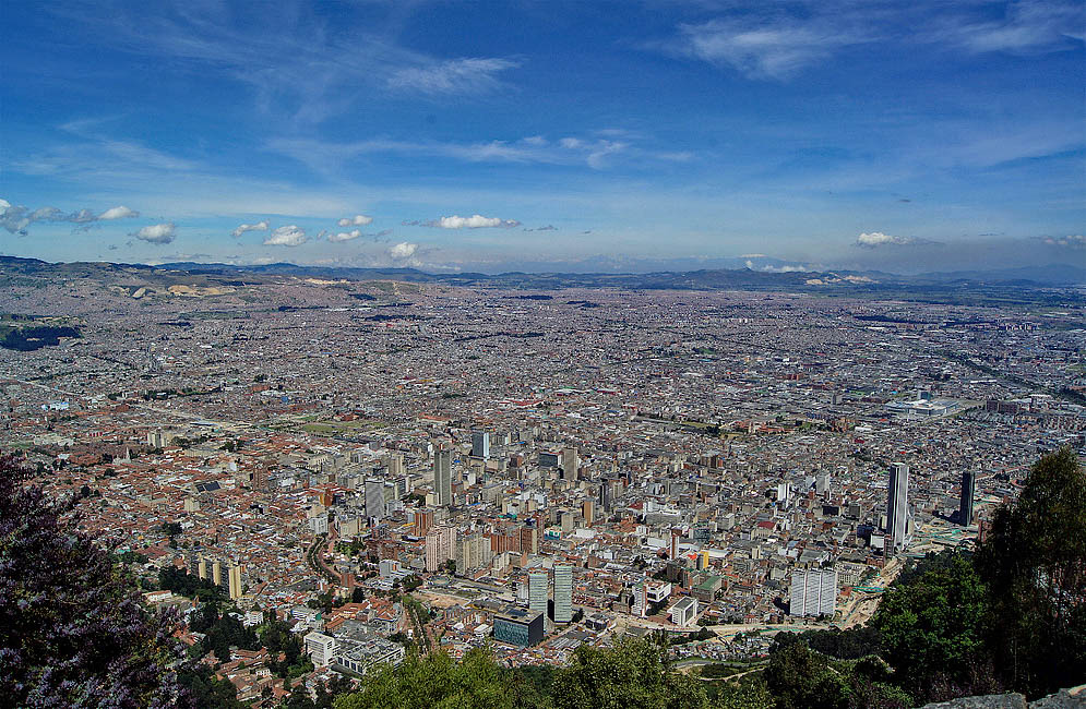 Bogotá Colombia A vista of Bogotá under blue skies with a snow-cap mountain in the background