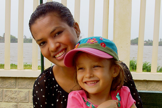 Child sitting on Colombians moms lap happy together