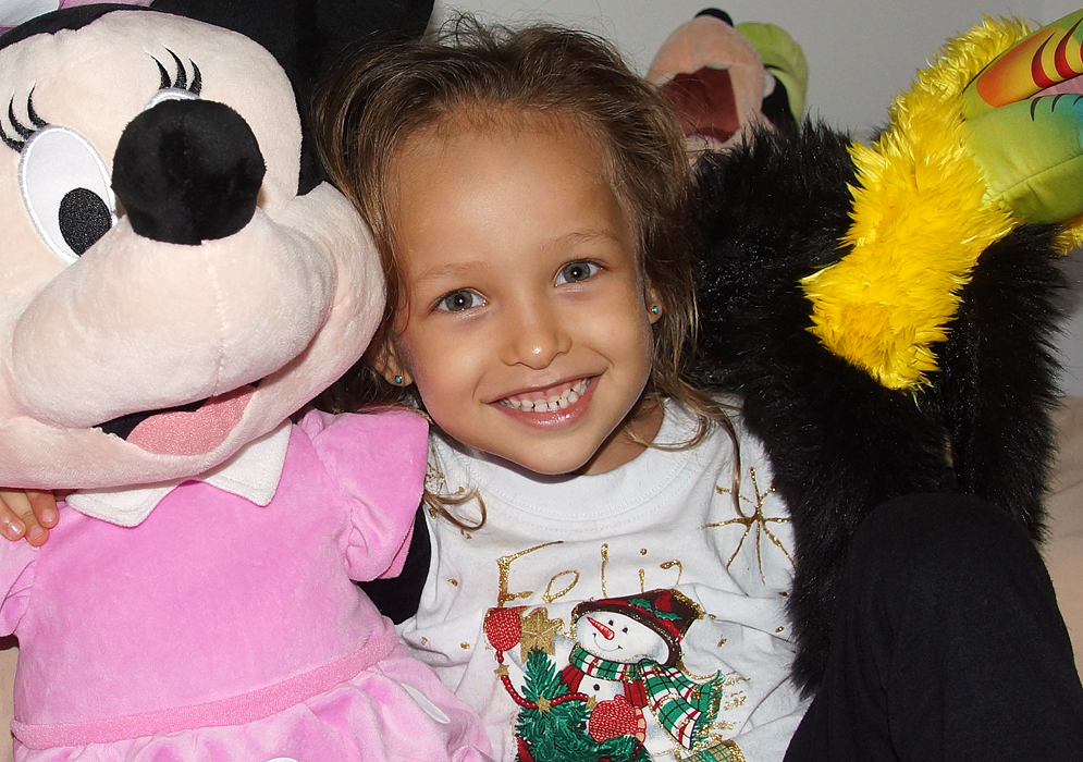 Three year old playing with her stuff animals