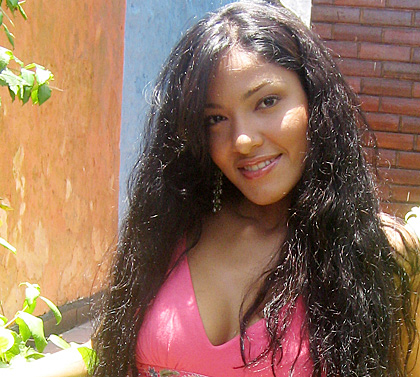 Colombian Mail Order Bride with pink shirt and long black hair