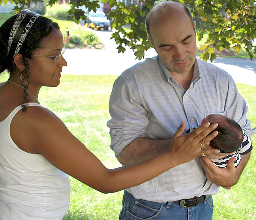 Colombian wife and American man holding their newborn baby