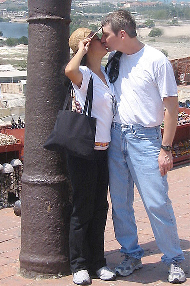 Colombian wife and American man kissing in Cartagena