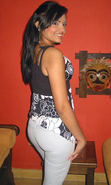 Colombian Woman With Hourglass Shape Colombian woman with long dark hair, defined cheekbones, an hourglass figure, and a slight turn of her body emphasizing her curves