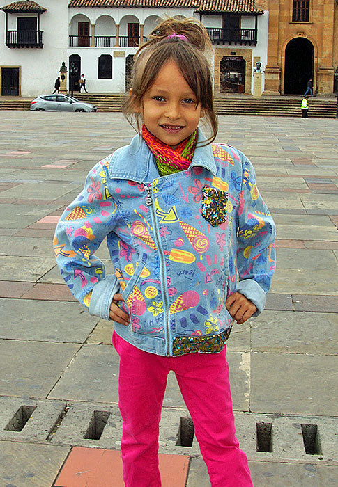 Little girl wearing bright colors on a cool day