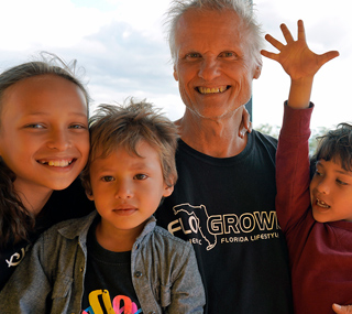 Smiling dad and owner of International Introductions with his children, Danica Alejandra, Derick Quinn and Dante Colt outdoors