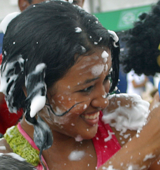 Carnival spectators covered in white foam