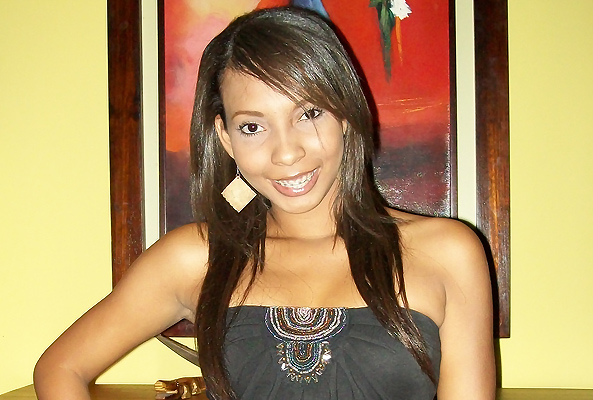 Dark-skin, smiling Latin woman with white blouse