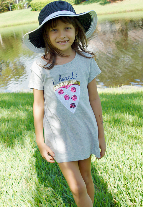 A gorgeous little girl cupping hanging turquoise flowers