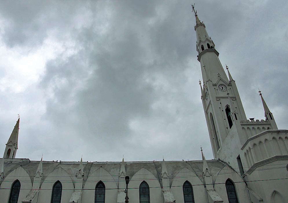 Looking up the tower of a white church