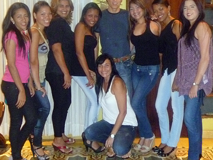 A pleased man posing with attractive Colombian women after his introductions