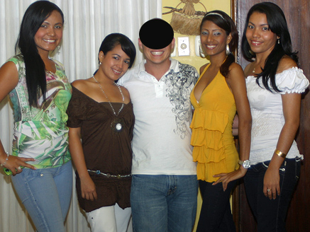 A pleased man posing with attractive Colombian women after his introductions