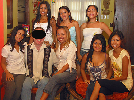 A pleased man posing with attractive Colombian women after his introductions