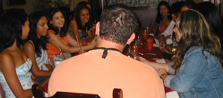 Man talking with Colombian women at a restaurant during marriage-minded introductions