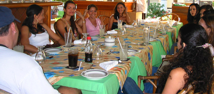 Man meeting Colombian women at a long lunch table during Latin matchmaking introductions