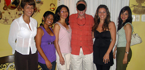 A senior American man posing with five attractive Colombian ladies after his romance tour introductions