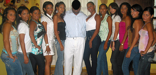 An American Black man posing with eleven attractive Latin women after his romance tour introductions