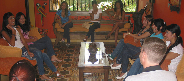 Several South American women seated around a table meeting a single gentleman in Colombia
