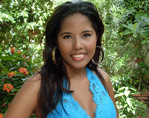 Head photos of tan skined Hispanic woman in a garden