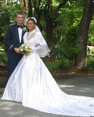 American Man and Colombian Woman wearing a long white wedding gown