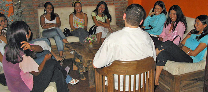 Latin Matchmaking Tour — Casual Lounge Introduction Small group mixer with Colombian women and one man talking in a lounge