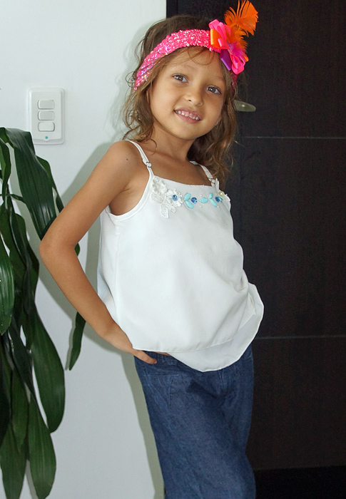  A lovely treat posing with her white blouse, blue jeans and pink hair band 