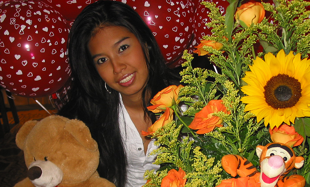 Colombian wife reciving gifts of flowers, ballons and cake