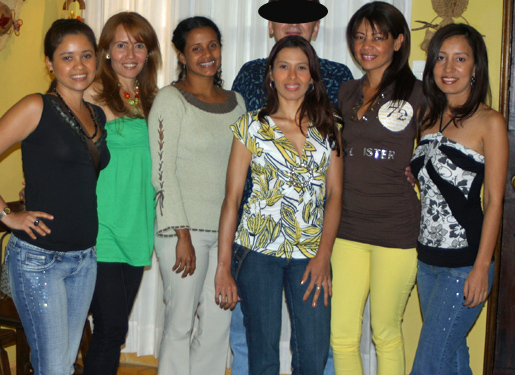 One man posing for a photo in the middle of eight South American women that he was introduced to