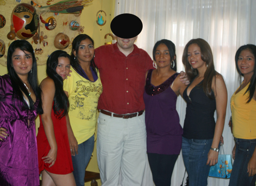 One man posing for a photo in the middle of eight South American women that he was introduced to