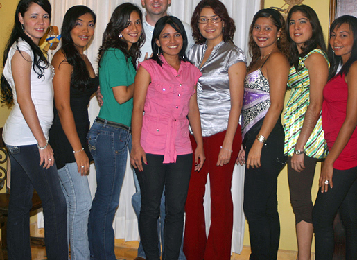 One man posing for a photo in the middle of eight South American women that he was introduced to