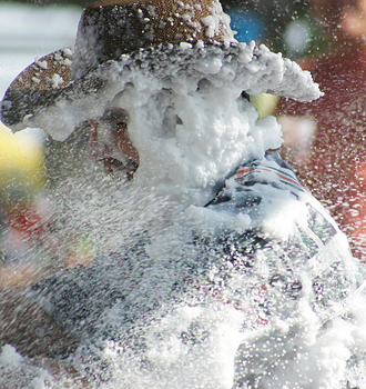 Carnival spectators covered in white foam