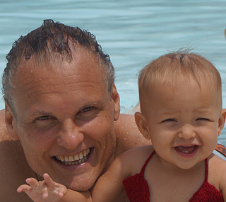 Jamie, the owner of International Introductions a renown marriage agency in South America and his baby daughter in a pool