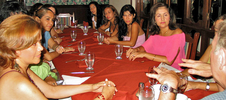 Women seated around a restaurant table looking attentive during a matchmaking introduction meeting